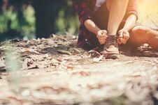 Young Woman Hiker Stops To Tie Her Shoe On A Summer Hiking Trail Stock Images