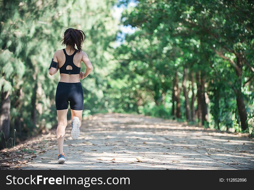 Young fitness woman jogging in park.