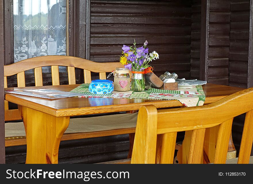 Table in Slovak restaurants, chairs and decoration, wooden house