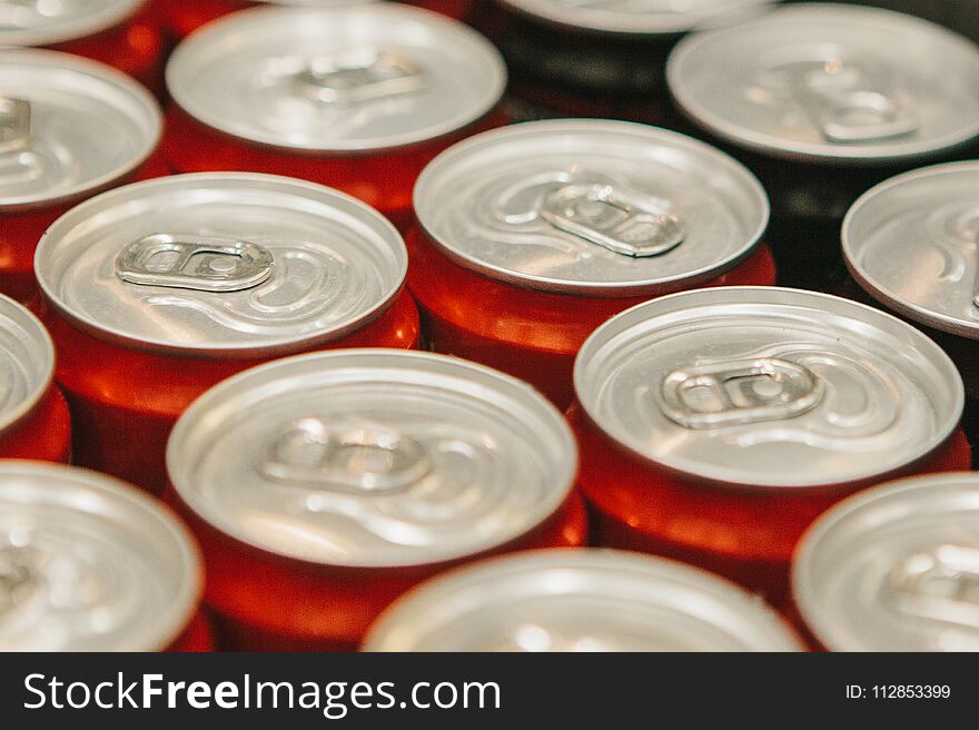 Many metal cans with cool drinks. A group of objects. Beverages