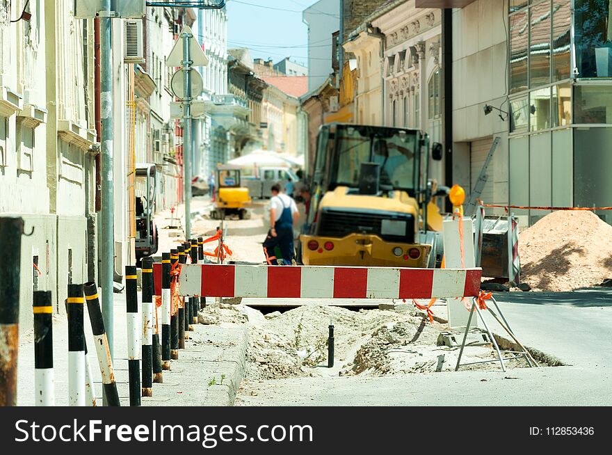 Work Ahead Street Reconstruction Site With Sign And Fence As Road Barricade