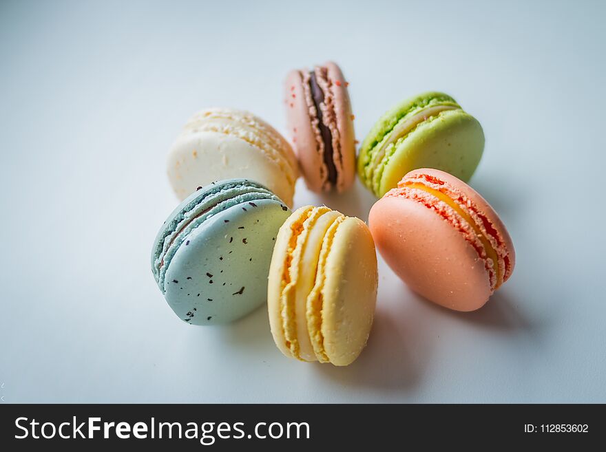 A french sweet delicacy, macaroons variety closeup. Macaroons on white background.Tasty colorful macaroon isolated on