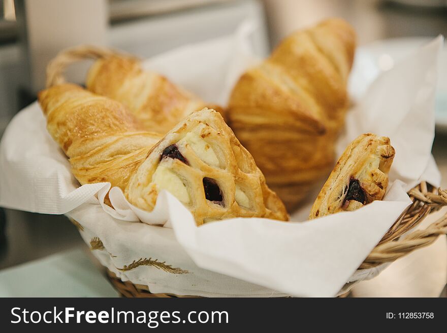 Traditional French croissants lie in the basket. Nutritious and delicious food.