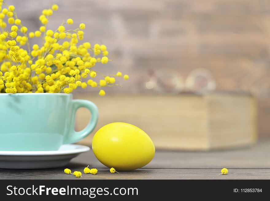 Yellow Easter egg and spring flowers