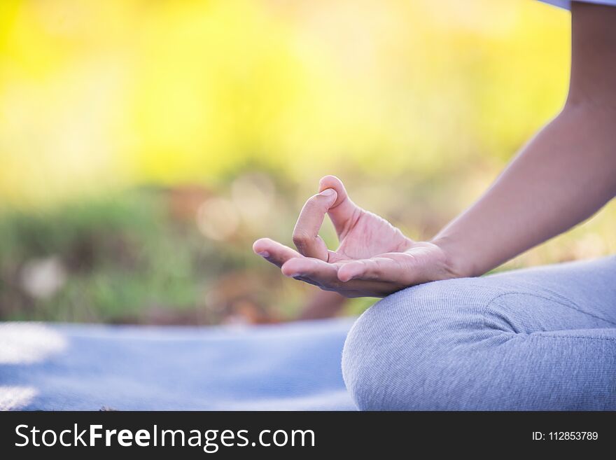 Young asian woman doing yoga in the park