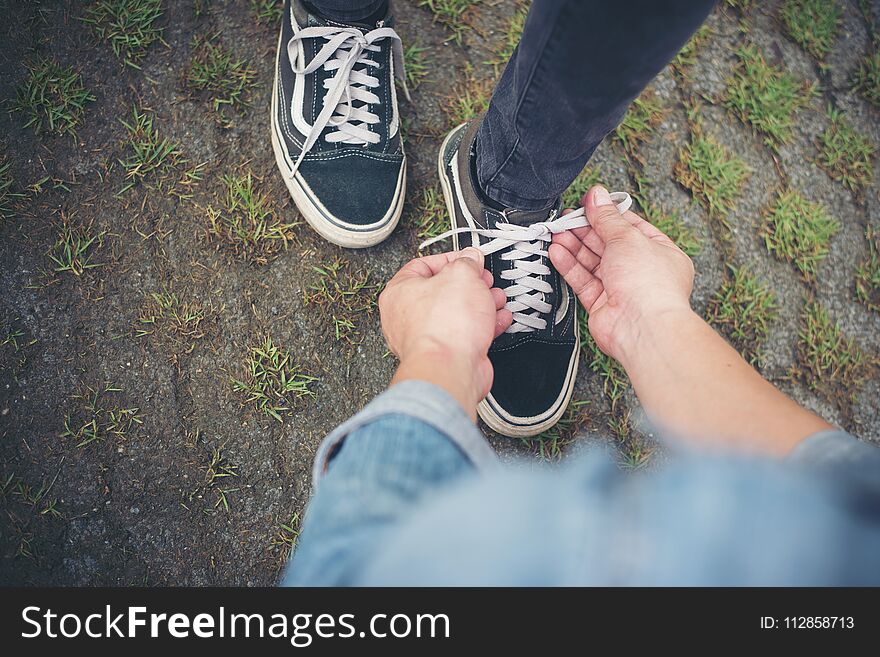 Hipster Boyfriend Tying Shoes To His Girls While Go The Relaxing