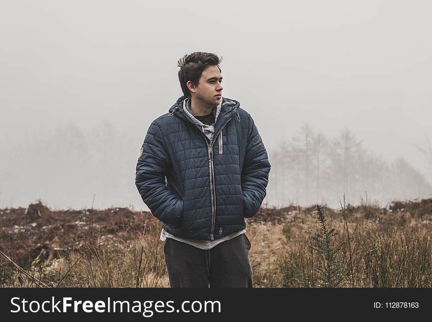 Man Wearing Black Zip-up Hooded Jacket Standing