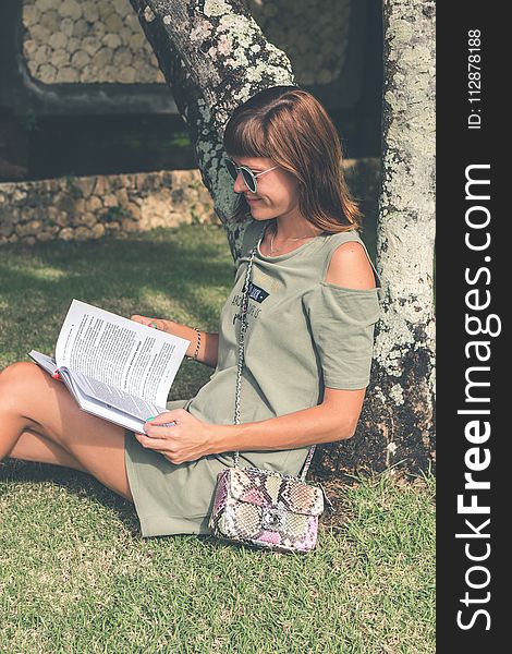 Woman In Gray Dress Reading Book At Daytime