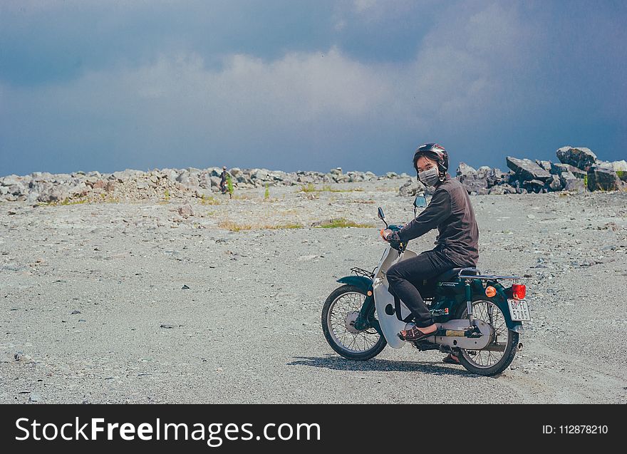 Person Wearing Mask on Motorcycle