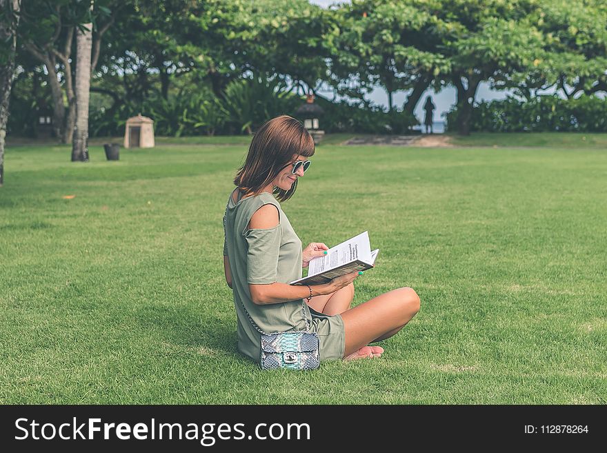 Woman Wearing Green Top Reading Book