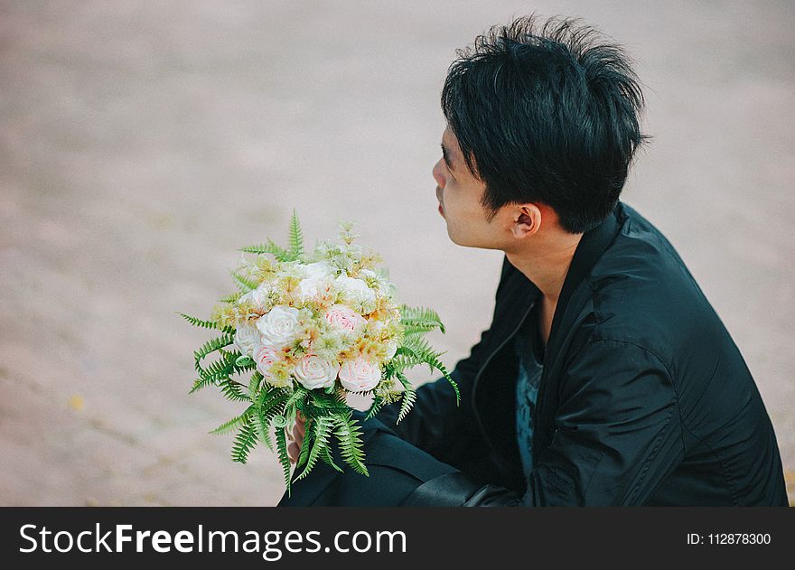 Person Holding Bouquet Of Roses