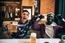 Cheerful Male Friends Having Fun At The Beer Pub Celebrating Victory Of Their Favorite Team Watching Game On TV And Shouting Royalty Free Stock Image Cheerful Male Friends Having Fun At The Beer Pub Celebrating Victory Of Their Favorite Team Watching Game On TV And Shouting Royalty Free Stock Image