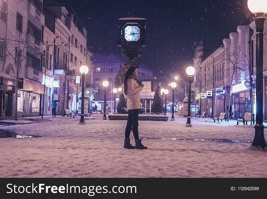 Woman Walking on Street Near Light Post during Winter Season