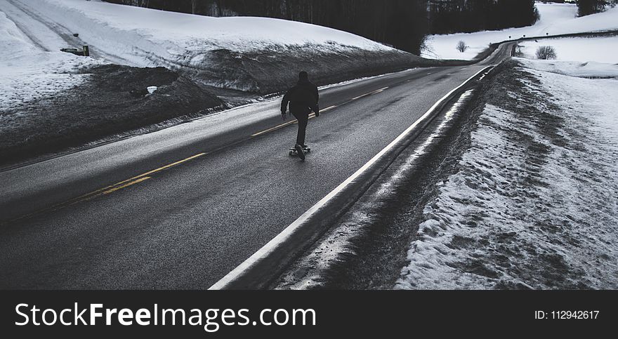 Person Running on Asphalt Road