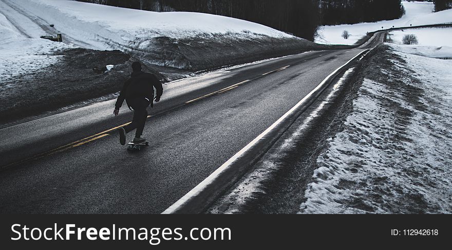 Grayscale Photo of Man Walking on Road