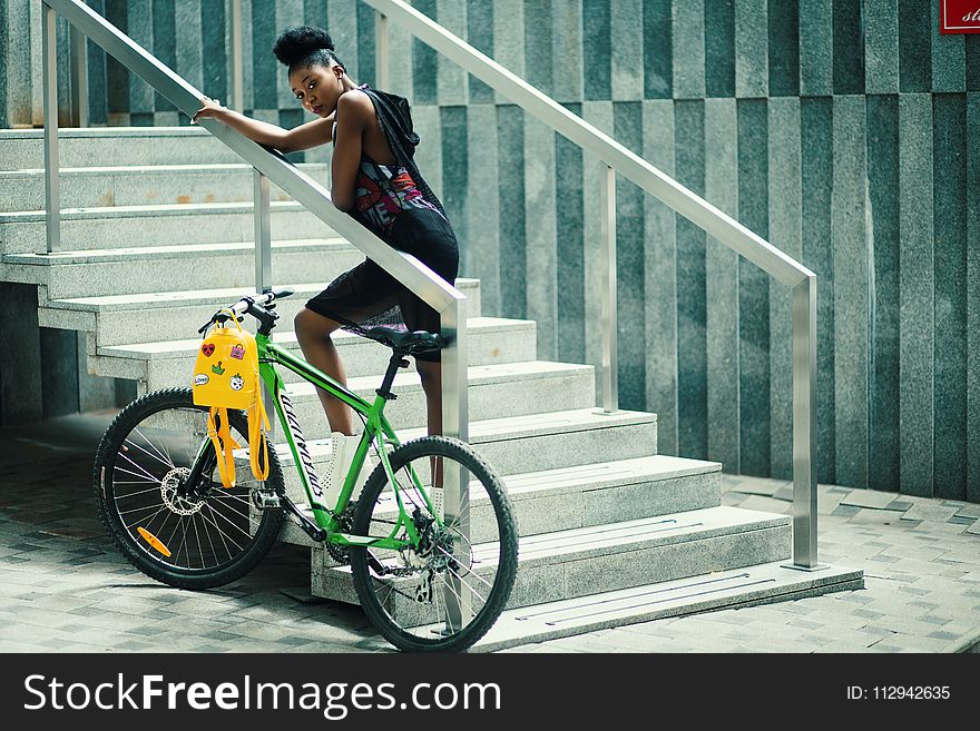 Woman Wearing Gray Sleeveless Hooded Top Standing In The Stair