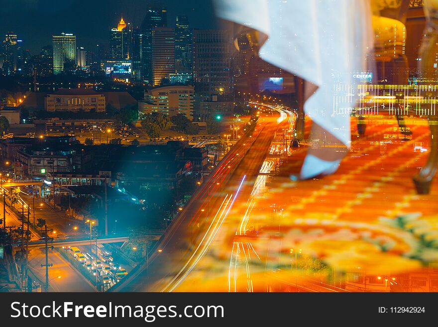 The metropolis at night is filled with tall buildings and colorful lights.