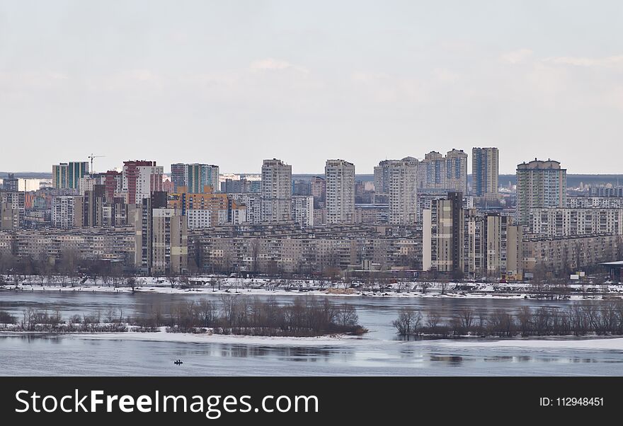 Kiev, March 24, 2018, Ukraine. View of the city and real estate through the winter river in the ice
