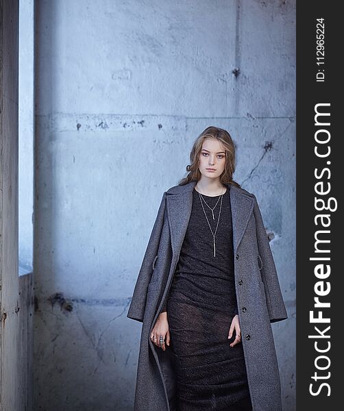 Portrait of modern female in a grey coat. Portrait of modern female in a grey coat.