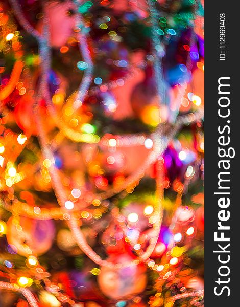 Decorated Christmas tree and colorful garland lights, defocused background, bokeh effect. Decorated Christmas tree and colorful garland lights, defocused background, bokeh effect.