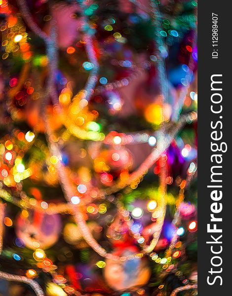 Decorated Christmas tree and colorful garland lights, defocused background, bokeh effect. Decorated Christmas tree and colorful garland lights, defocused background, bokeh effect.