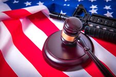 Gavel With Gun On Background Of USA Flag. Stock Photos