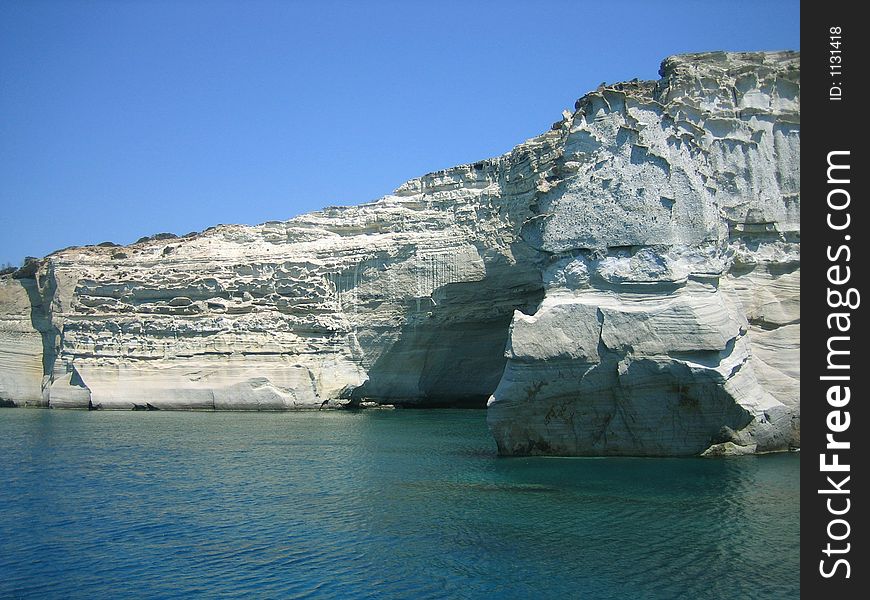 White rock sandwiched between blue sea and blue sky, Milos island, Greece. White rock sandwiched between blue sea and blue sky, Milos island, Greece