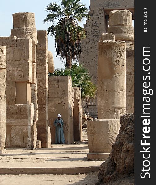 Local man standing against the wall at Luxor