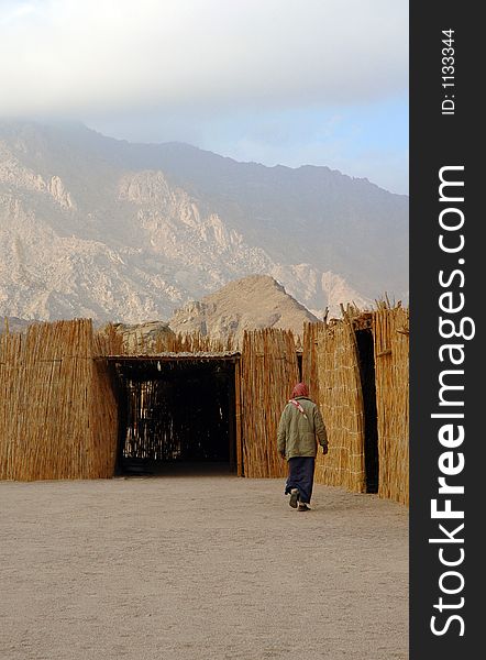 A man walking to his hut. A man walking to his hut