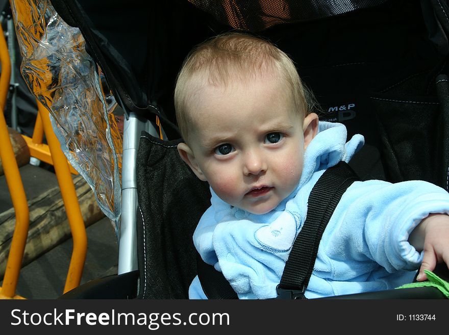 Happy child playing in pushchair