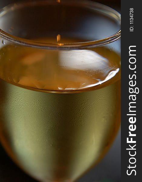 Glass of white wine, cropped with shallow depth of field. Glass of white wine, cropped with shallow depth of field
