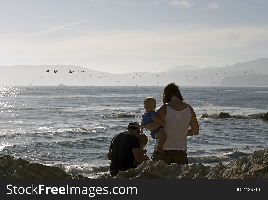 Young couple and their kid at the beach. Young couple and their kid at the beach.