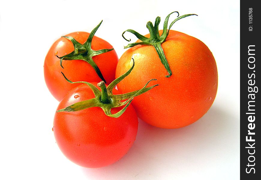 Red tomatoes on a white background. Red tomatoes on a white background.