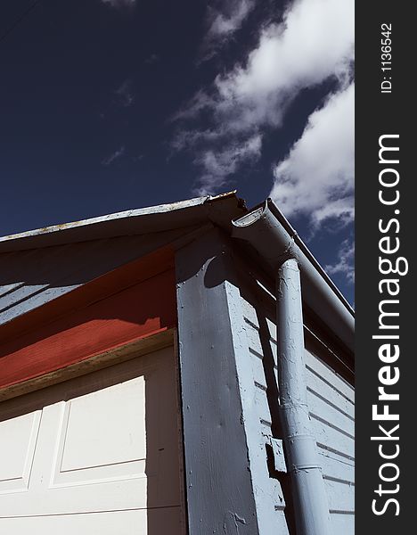 Colorful painted garage with blue sky background.