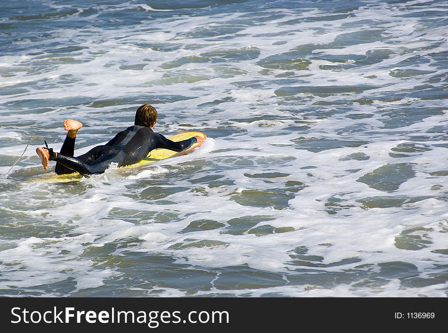 Surfer going into the surf with long board. Surfer going into the surf with long board