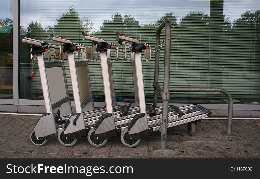 Chained trolleys in line at airport