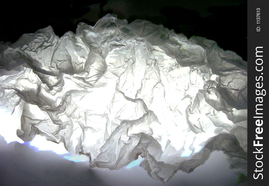 White light passing through wrinkled white paper. White light passing through wrinkled white paper