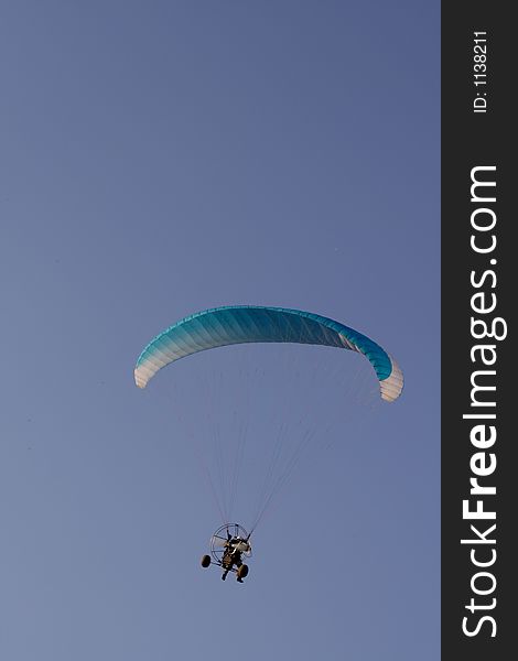 Flying paraglider in the blue sky. Flying paraglider in the blue sky