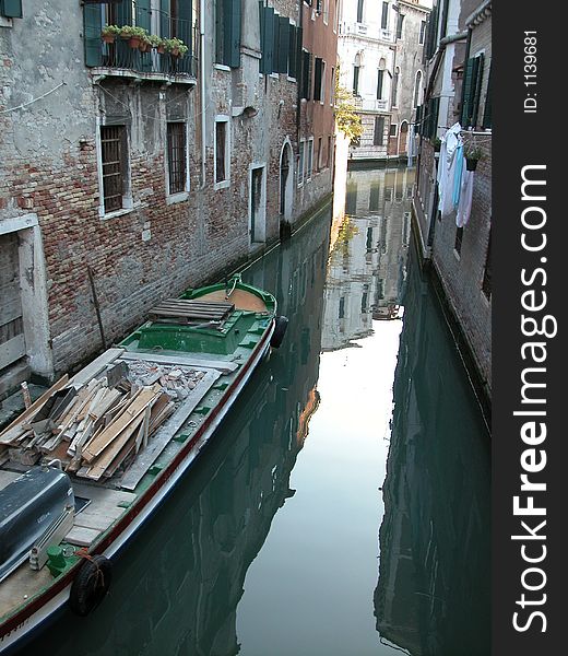 Back alley in Venice  water street with boat and laundry hanging to dry. Back alley in Venice  water street with boat and laundry hanging to dry.