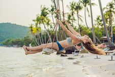 Vacation Concept. Happy Young Woman Sitting On Swing Enjoying Sea View Royalty Free Stock Image Vacation Concept. Happy Young Woman Sitting On Swing Enjoying Sea View Royalty Free Stock Image