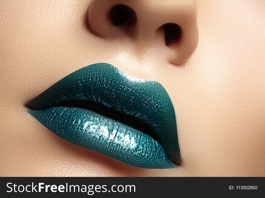 Glamour green Gloss Lips with sensuality gesture. style, closeup macro shot of female Lip stick Make-up. Sensuality mouth