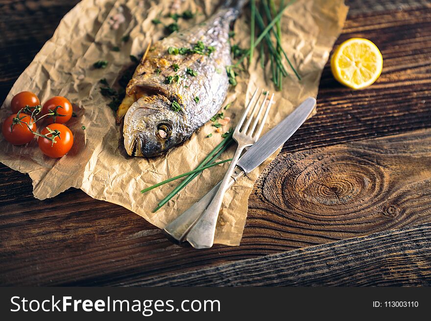 Gilthead seabream & x28;Sparus aurata& x29; baked in the oven with lemon, chive and salt. Gilthead seabream & x28;Sparus aurata& x29; baked in the oven with lemon, chive and salt.