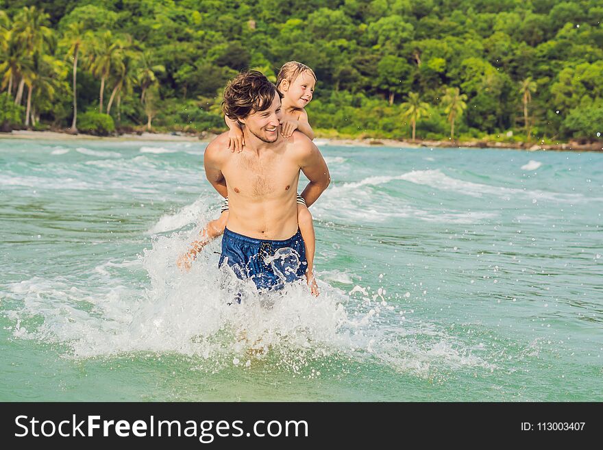 Dad Plays With His Son In The Sea