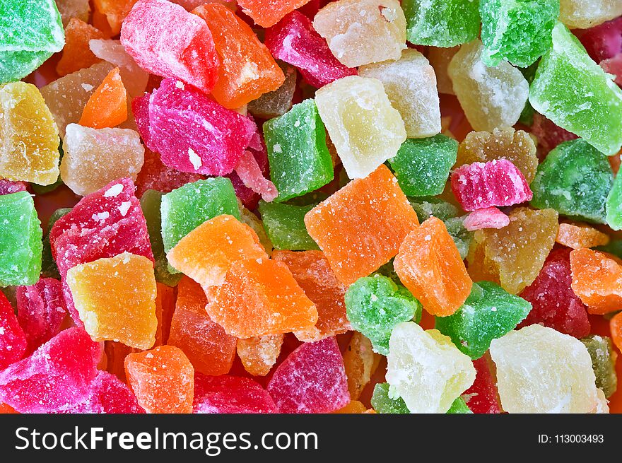 The candied pieces of dried fruit close up. Multi-colored appetizing candied fruits, selective focus