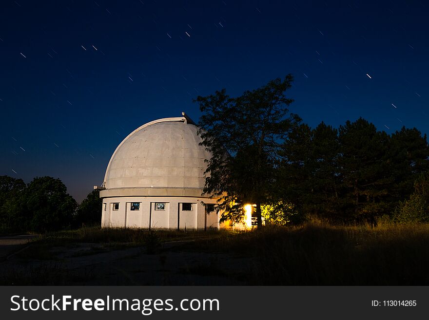 The dome of the astronomical telescope at night the stars Shine.