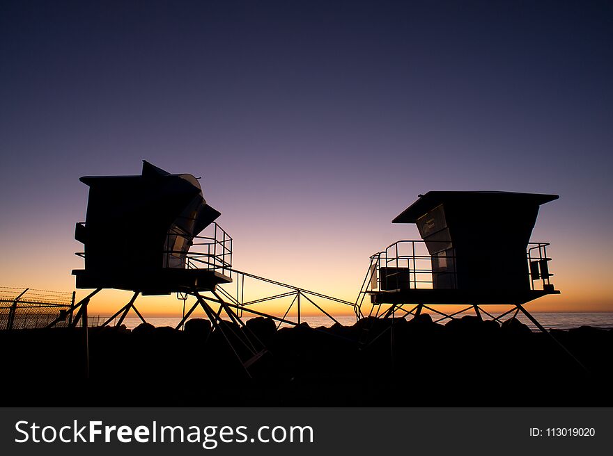 Silhouette of Life guard towers at Carlsbad Beach, CA. Silhouette of Life guard towers at Carlsbad Beach, CA