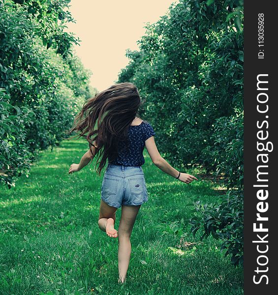 Photo Of A Woman Running On Green Grass