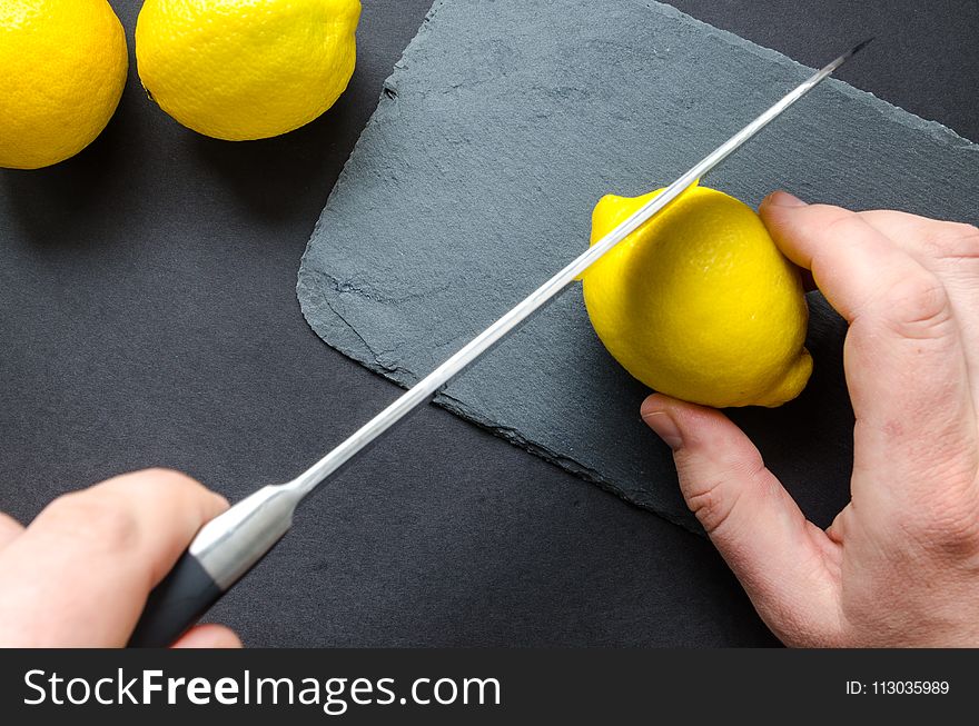 Photo of Person Slicing Lemon