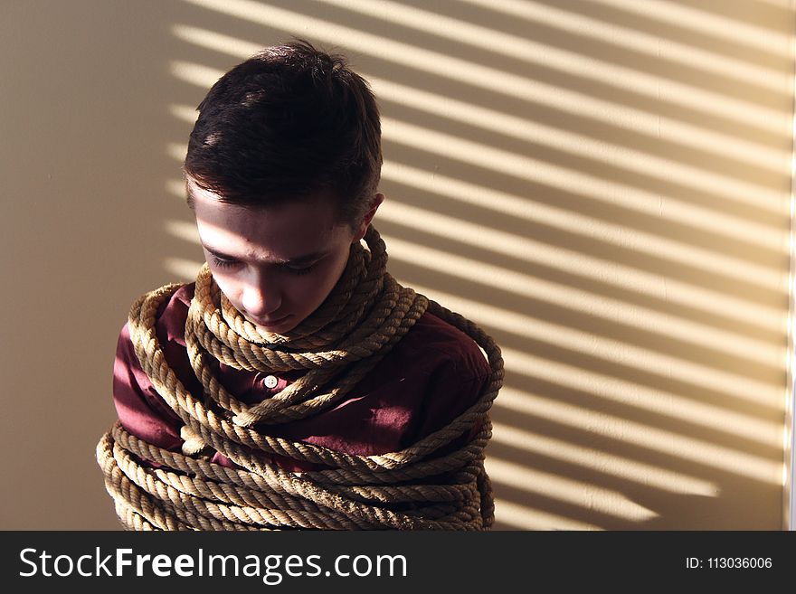 Photo of a Boy Tied With Ropes