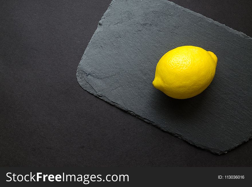 Photo of Yellow Lemon on Gray Surface
